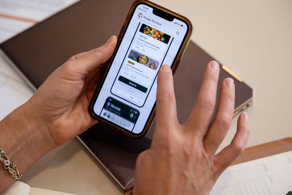 Scrolling through the Nudge Nutrition app on a phone