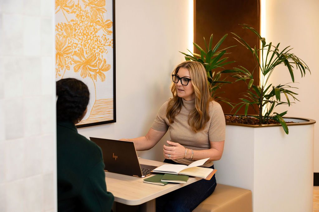 Nikki reviewing a client’s plan together at her desk